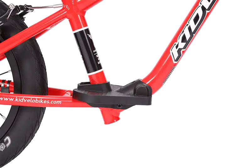 Close-up of a red balance bike frame with integrated footrest for comfort