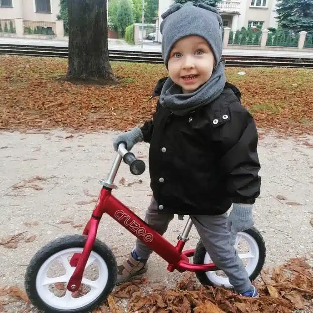 Cruzee-12-Balance-Bike-Red-Boy-on-bike-Winter-Kids-bikes-online