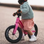 Kid on a Flamingo Pink Airo 12 Inch Balance Bike