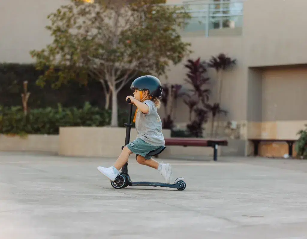 kid on black scooter